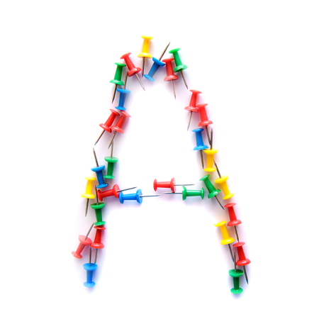 Letter A English alphabet from multicolored stationery office buttons, isolate on white backgroundの写真素材