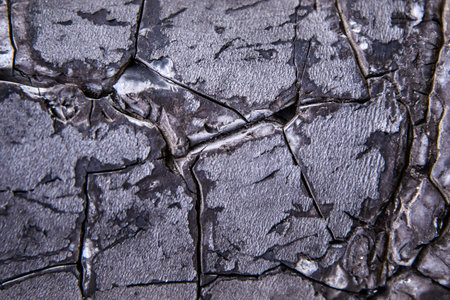 Abstract background of old black peeling paint with cracks