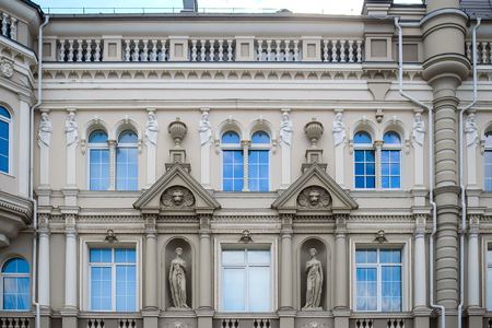 Russia, Kazan, April 27, 2018: a beautiful fragment of the facade of a modern building with statues in the old vintage European styleのeditorial素材