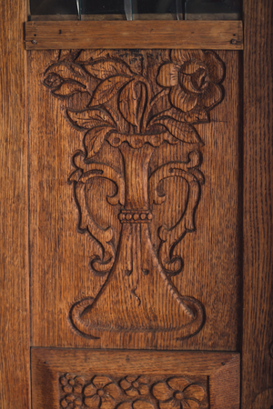 Carved fragment with flowers of an old wooden wardrobeの写真素材