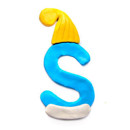 Blue plasticine letter S of English alphabet in winter yellow hat on white backgroundの写真素材