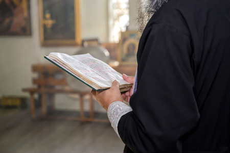The book with prayers in the hands of a priest in a Christian Orthodox Churchの写真素材