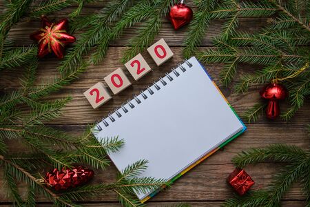 Christmas wooden background with warm tea mug, Notepad, scarf, toys for 2020 new year, holiday cardの写真素材