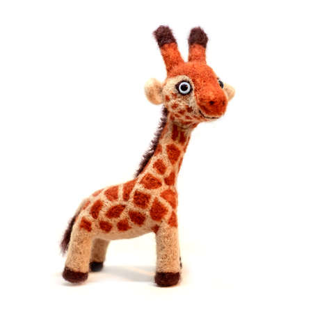 Cute funny little toy handmade woolen giraffe, felting from wool, isolate on a white backgroundの写真素材