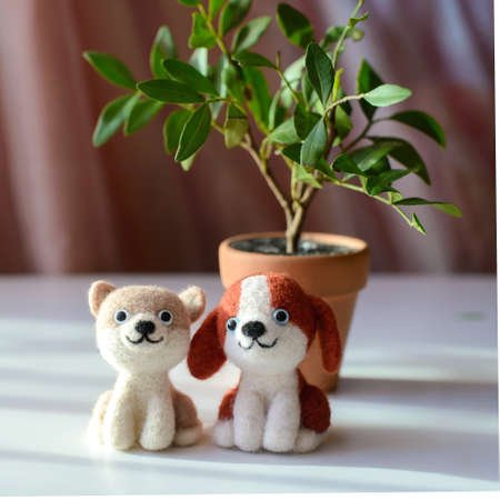 Cute woolly toy dogs under green leaves on a sunny day, felting woolの写真素材