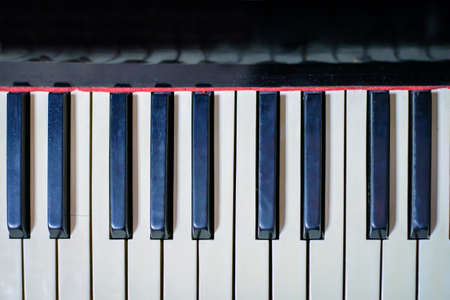 Black and white keys of an old piano closeup, abstract backgroundの写真素材