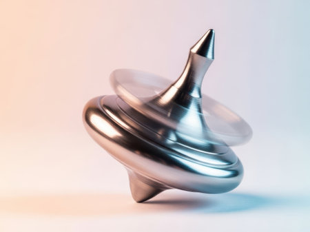 Metal spinning top, isolated on white backgroundの素材