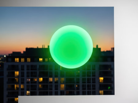 Green glowing orb isolated on white backgroundの素材