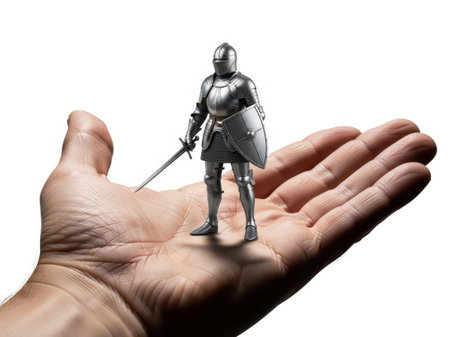 Hand holding knight figurine isolated on white backgroundの素材