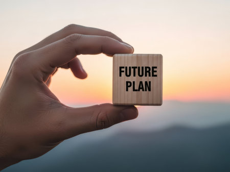 Hand holding future plan block isolated on white backgroundの素材