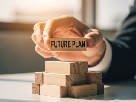 Hands holding future plan sign over wooden blocks, isolated on white backgroundの素材