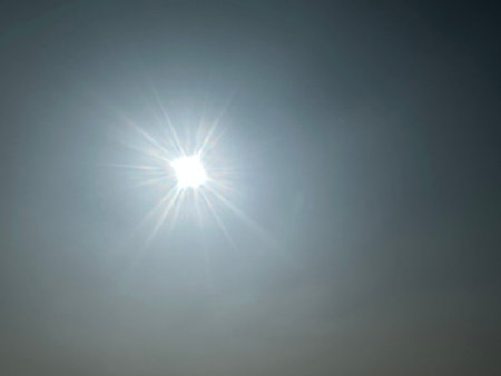 Sunburst emitting radiant light and lens flare creating an atmosphere. Sun shine creating shimmering...