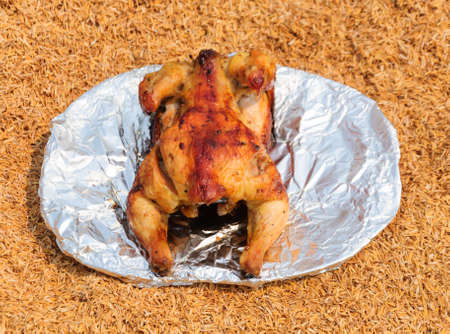 Grilled chicken on the dish over husk の写真素材