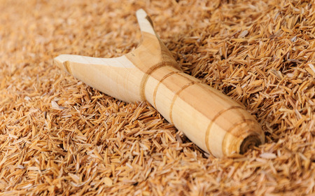 Wood slingshot catapult on husk backgroundの写真素材