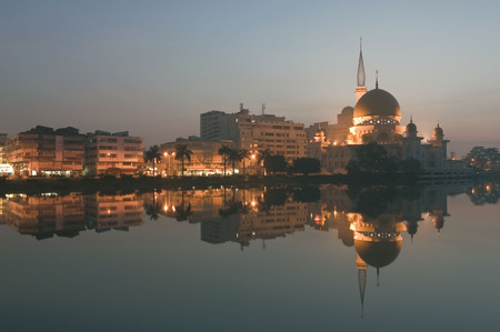 View and reflection of Klang Mosque during sunrise. Image has grain or blurry or noise and soft focus when view at full resolution. (Shallow DOF, slight motion blur)の写真素材