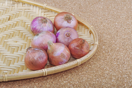 Fresh red onions on a wooden backgroundの写真素材