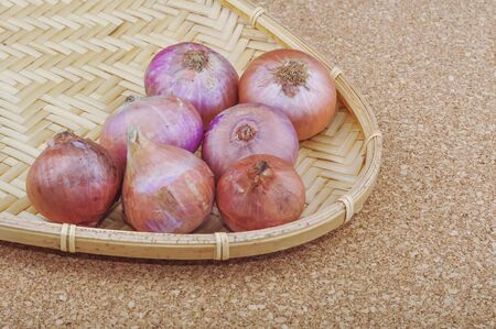 Fresh red onions on a wooden backgroundの写真素材
