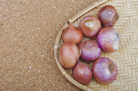 Fresh red onions on a wooden backgroundの写真素材