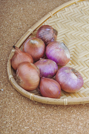 Fresh red onions on a wooden backgroundの写真素材