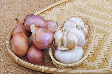 Red onions with garlic on wooden backgroundの写真素材