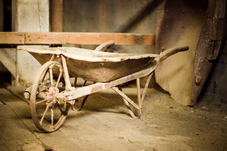 historic aged and rusty wheelbarrow in gold mining mill in Coloradoの写真素材