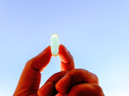 Fish oil capsules with omega 3 and vitamin D for daily supplement, Healthy diet, Holding on hand