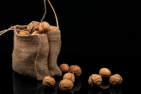 Walnuts in the bag on a black background.の写真素材