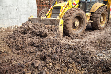 The tractor aligns the site for construction.