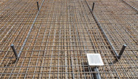 Setting of plastic pipes for a pool and strengthening by a metallic armature before an inundation a...