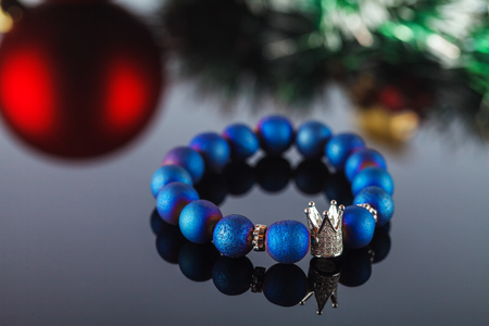 Exquisite women's bracelet made of natural stones, agate and sugar quartz with accessories that are encrusted with cubic zirconias. Close-up. Studio lightingの写真素材