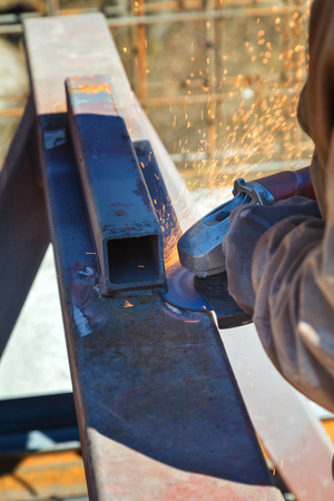 Worker cuts a metal structure with an electric flexの写真素材
