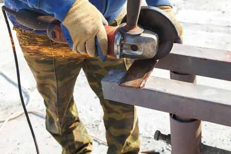 Worker cuts a metal structure with an electric flexの写真素材