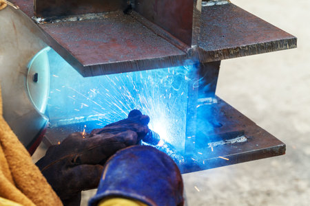 Welding work, welder welding metal material in heavy industry manufacturing