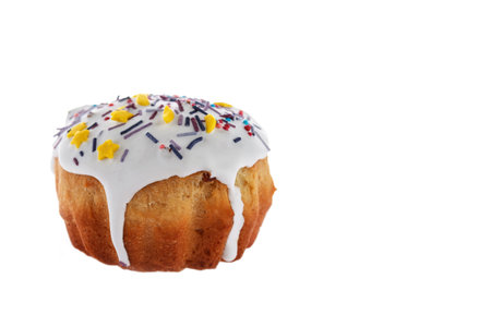 Easter cake freshly baked at home with icing and colored decorations isolated on a white background....