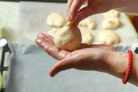 The process of making buns with cherries from yeast dough. The concept of home baking.