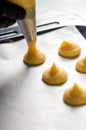 The process of making profiteroles using a cooking bag. confectionery. close upの写真素材