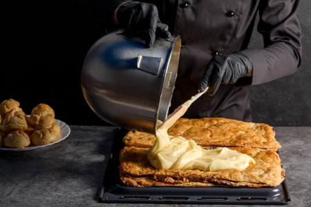 Process making a Napoleon cake with poppy seeds and cherries. close upの写真素材