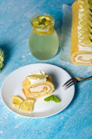 Lemon roll with fruit curd, with mint, close-up. On a blue backgroundの写真素材