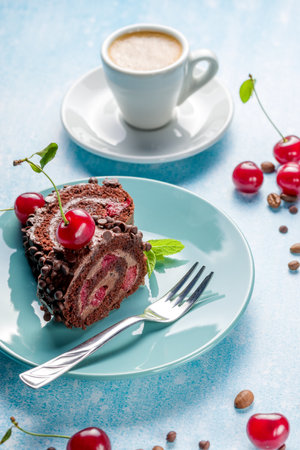 Chocolate roll cake with cream and cherry on a light background.の写真素材