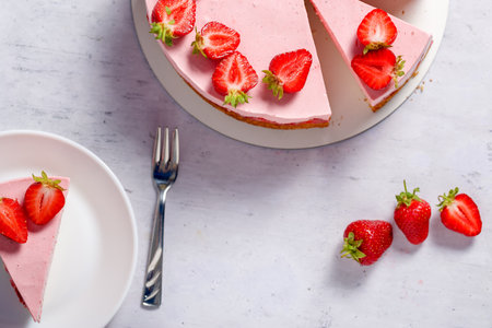 Strawberry cake. Menu concept. Homemade strawberry cake decorated with strawberries and mint leaves. Flat layの写真素材