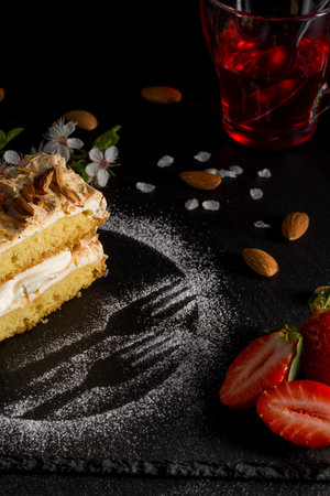 Norwegian cake. With meringue, whipped cream and almonds. Dark background.の写真素材