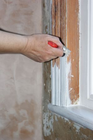 Painting a window frame with white undercoatの写真素材