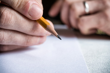 Pencil in hand manの写真素材