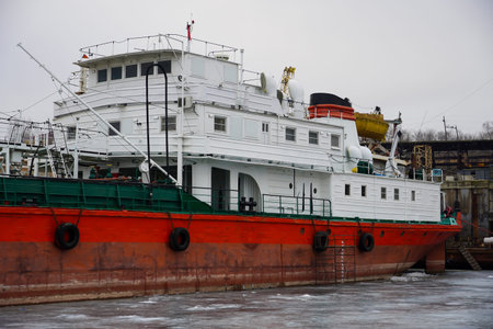 Old rusty motor ship. Volgograd. Krasnoarmeysky Zaton, wintering of ships on a frozen river.