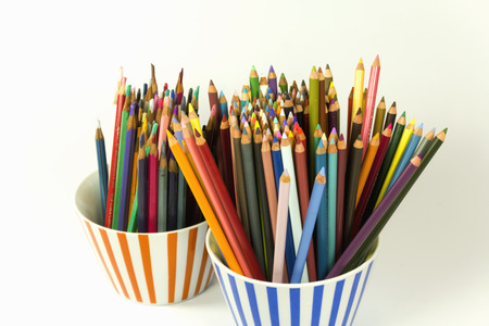 used and new color pencils in a glassの写真素材