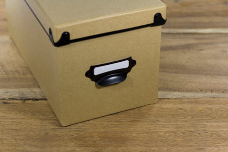 brown storage box isolated on wooden background
