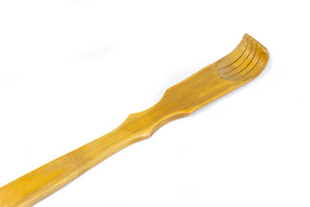 wooden backscratcher isolated on white backgroundの写真素材