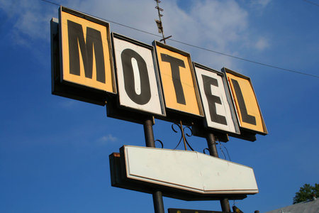 Vintage motel sign against a blue sky.の写真素材
