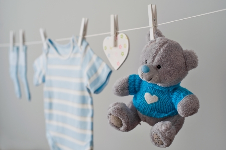 blue baby clothes on the clotheslineの写真素材
