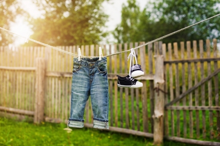 children's jeans and sneakers on the clotheslineの写真素材
